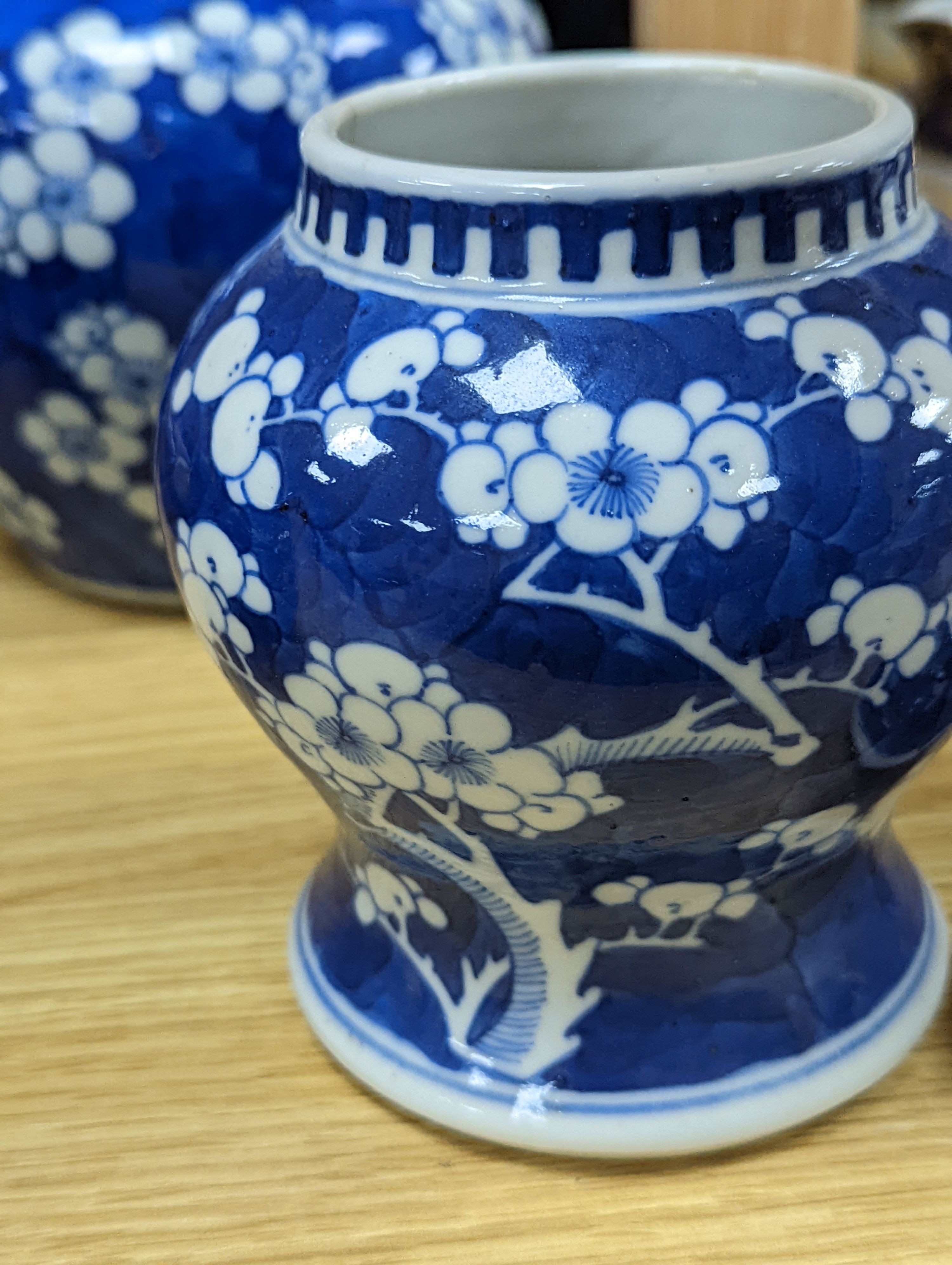 Three Chinese blue and white prunus decorated jars and covers, 19th/20th century, with four character marks 18cm